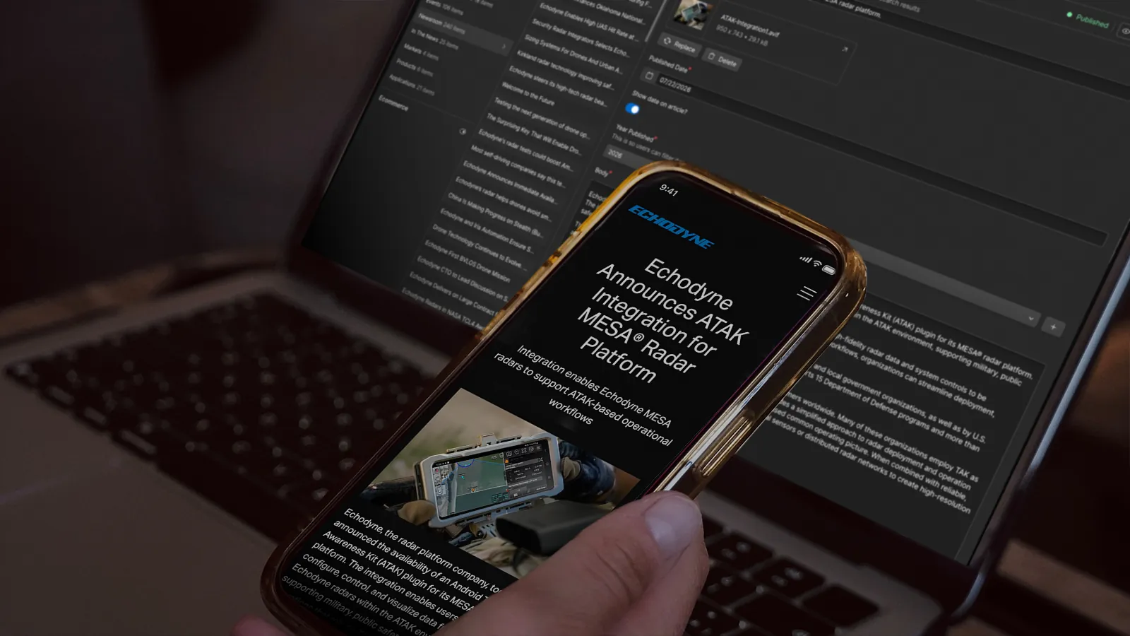 Echodyne news story on a phone held over a laptop